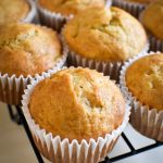 Fluffy vegan banana muffins lined on a cooling rack.
