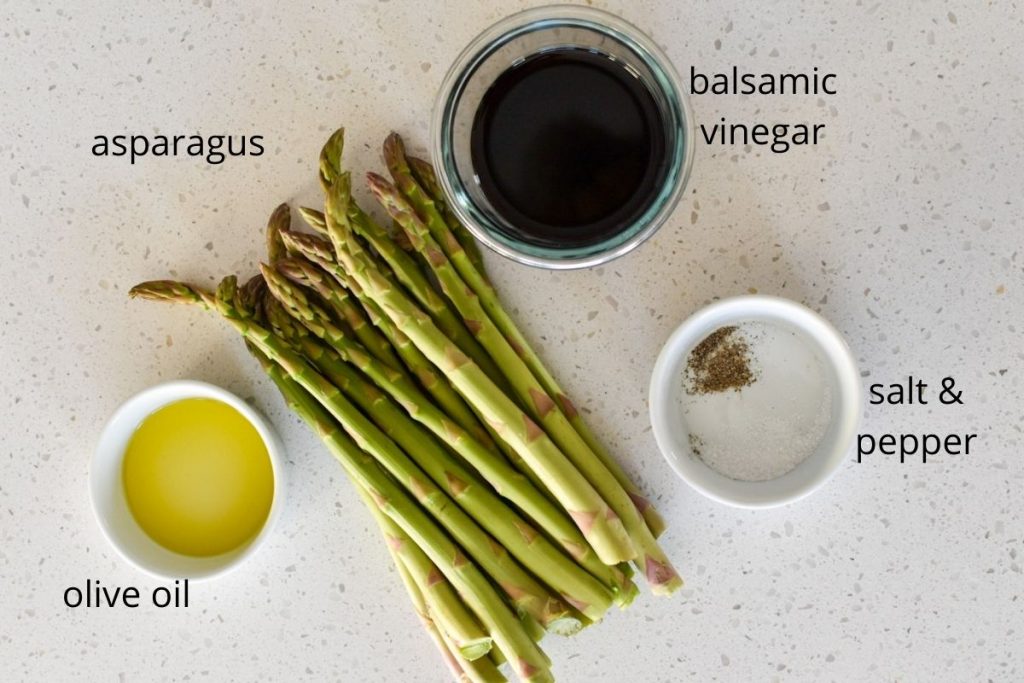 Picture of fresh asparagus, balsamic vinegar, olive oil, salt and pepper on a countertop with the text of each item.