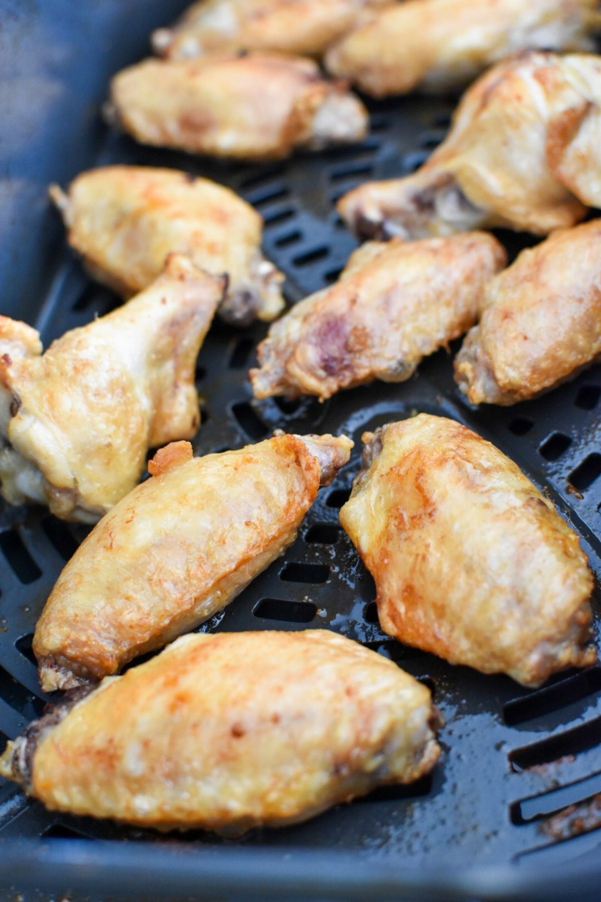 Cooked wings in an air fryer.