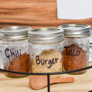 Chili, Burger and Taco seasonings in three small mason jars.