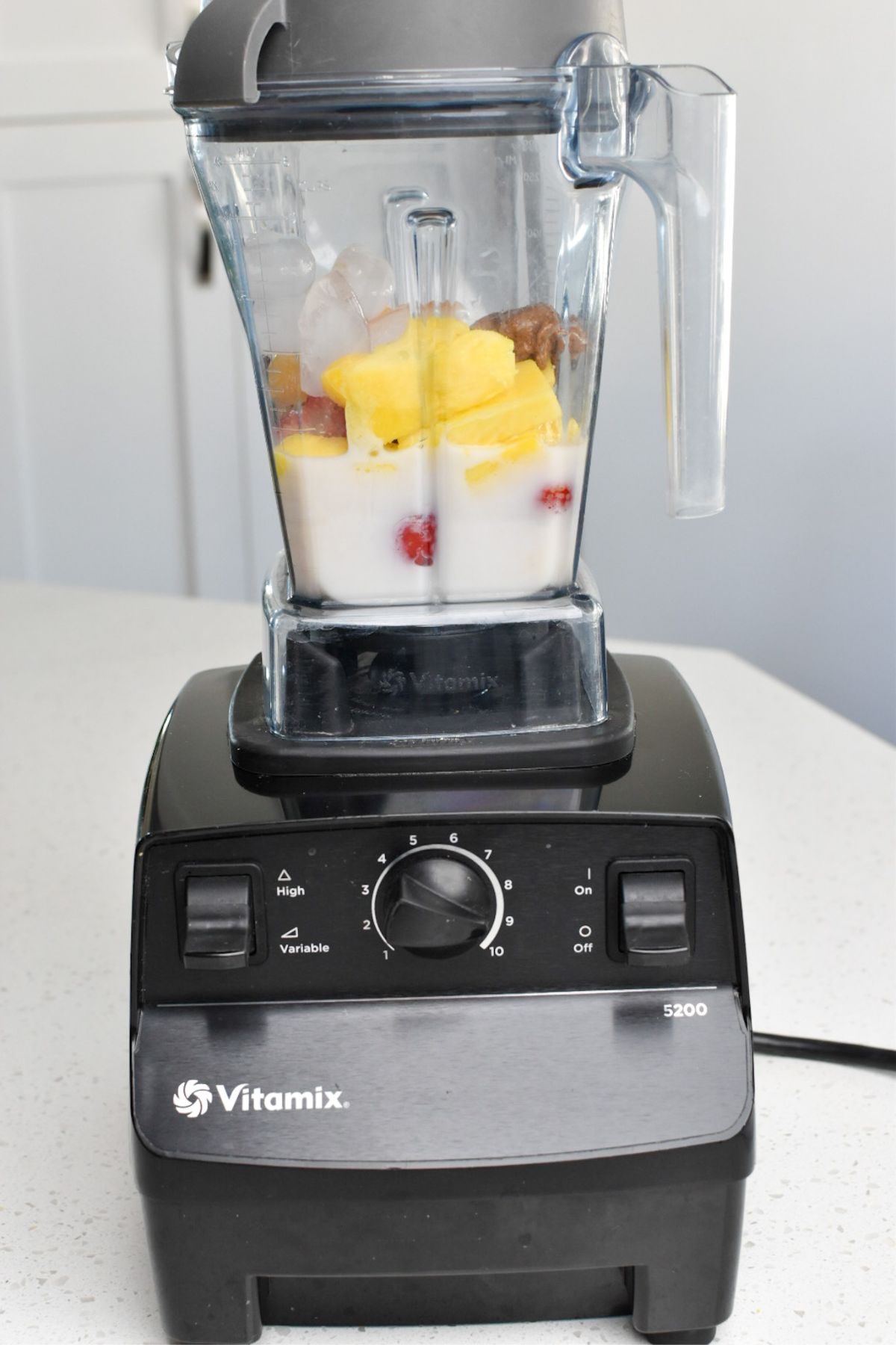 Fruit and almond milk in a Vitamix blender.