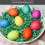 The colored eggs on green Easter grass with the text: DIY Easter Egg Dye.