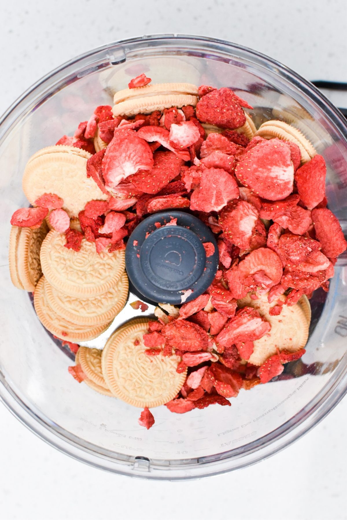 Golden Oreos, and freeze-dried strawberries in a food processor.