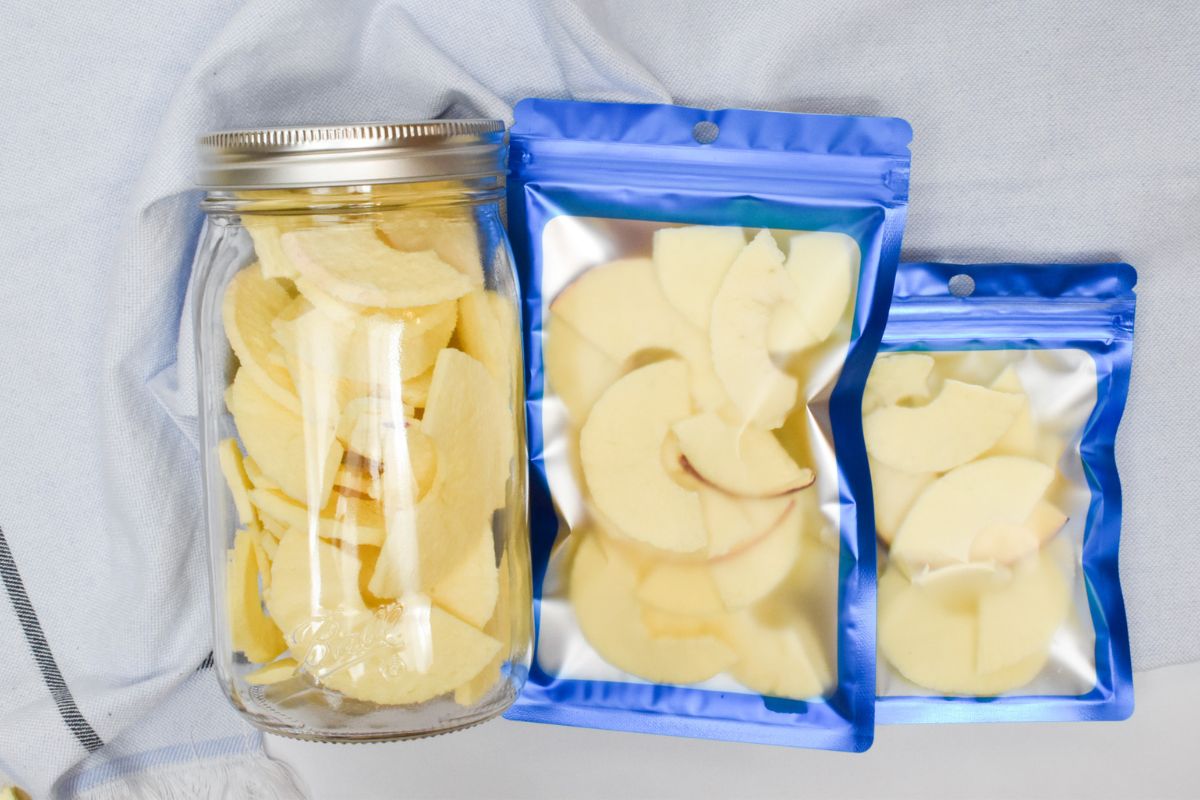 Freeze dried apples in a mason jar and in two mylar bags.