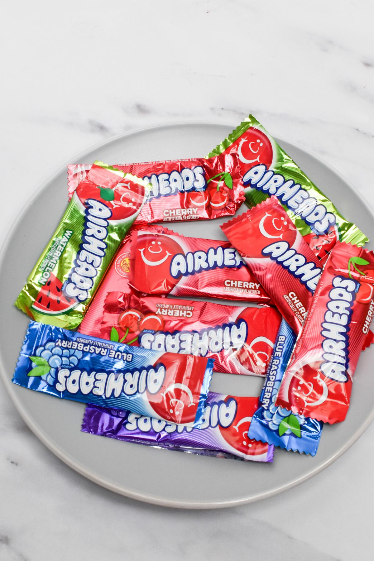 Airheads still in their wrappers on a plate.