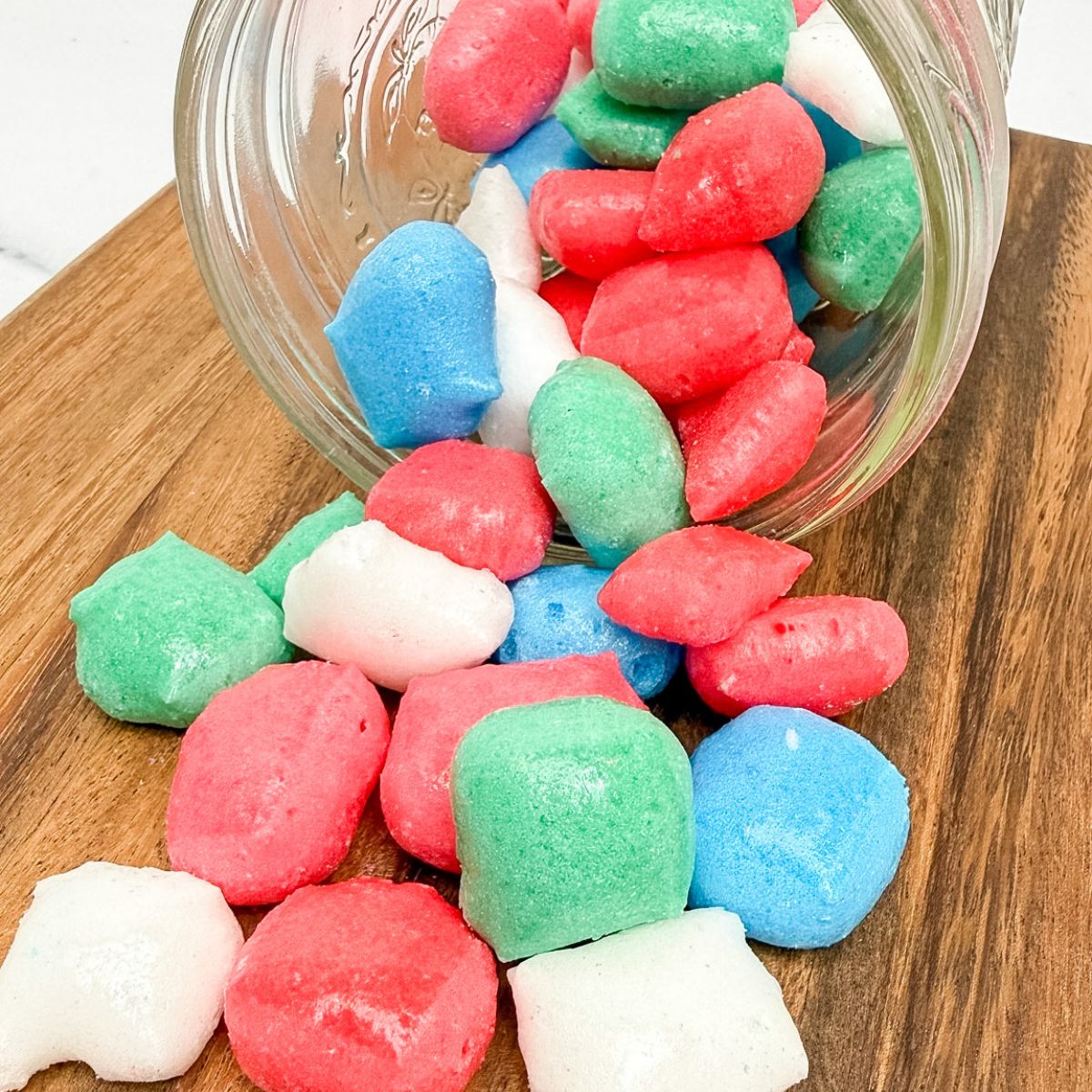 A glass jar with freeze dried Airheads in it.