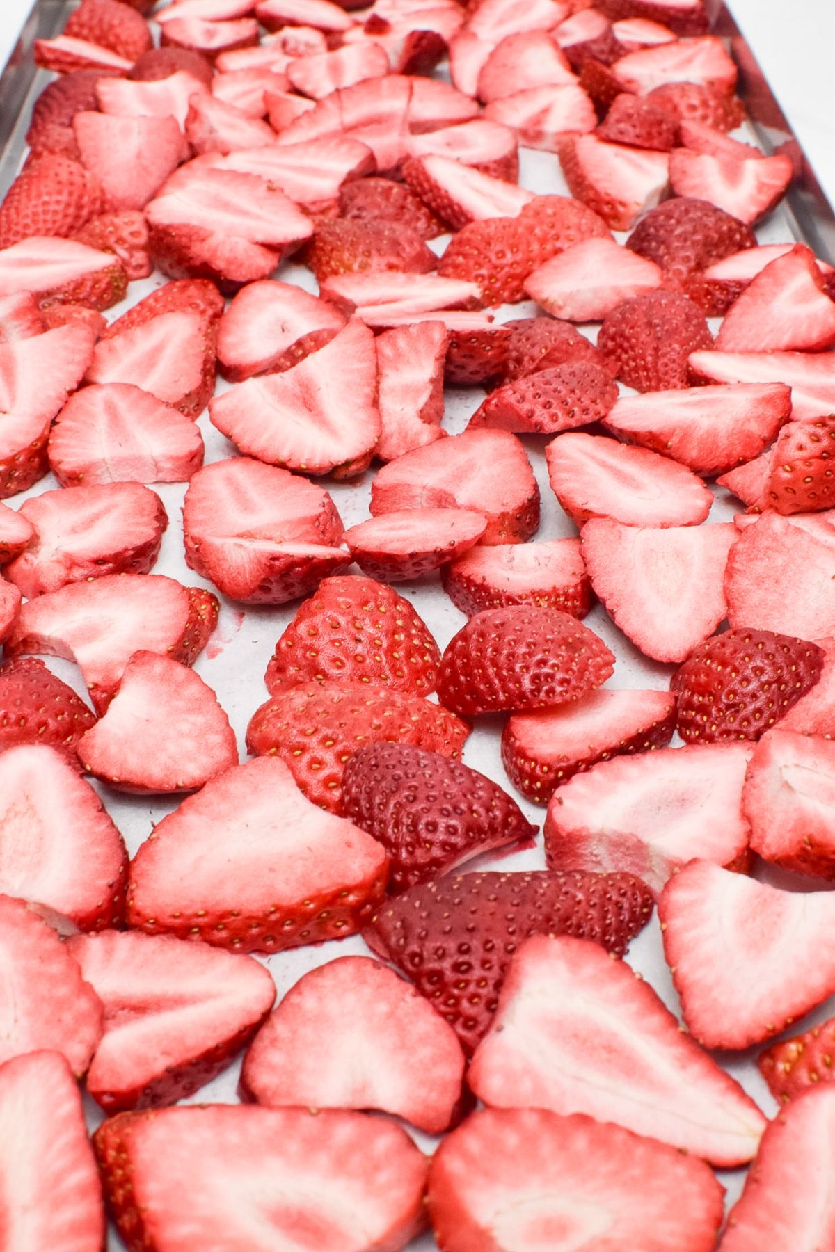 A tray of sliced freeze dried strawberries.